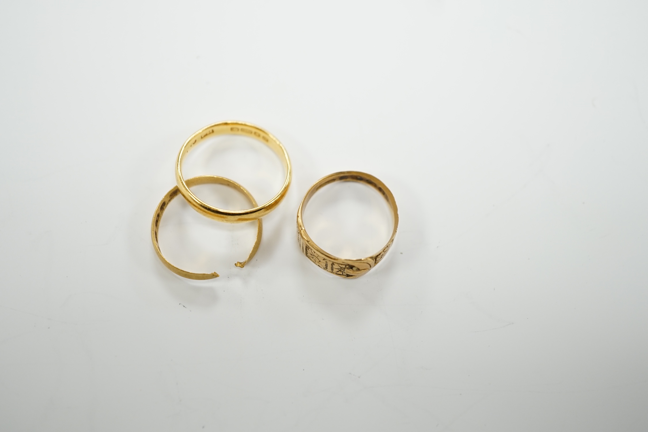 Two 22ct gold wedding bands (one cut), 5.8 grams and an 18ct gold buckle ring, 2.9 grams.